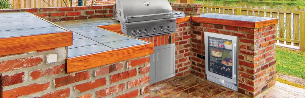 built-in outdoor fridge in an outdoor brick kitchen